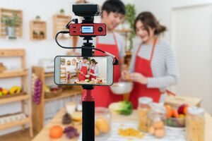 Camera-for-photographer-or-video-and-live-streaming-concept--closeup-smart-mobile-phone-taking-live-of-happy-asian-lover-or-couple-cooking-in-the-kitchen-room-912895022-5b30ac9430371300366f48ae.jpg
