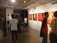 Visitors to the exhibition appreciating the artwork