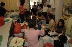 Concerned volunteers sorting through donated goods.