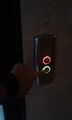 Call station with red and green illuminating button.