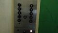 Car station featuring the standard Otis black buttons.