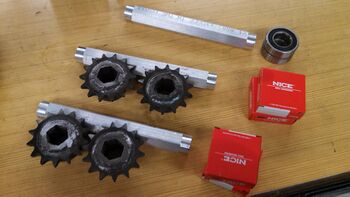 Intermediate axles with sprockets and bearings.